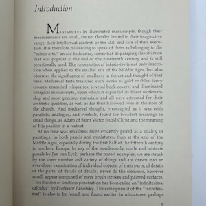 May include: An open book page with the title "Introduction" at the top. The text discusses miniatures in illuminated manuscripts, their artistic value, and the concept of "infinitesimal calculus."