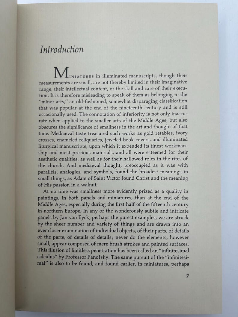 May include: An open book page with the title "Introduction" at the top. The text discusses miniatures in illuminated manuscripts, their artistic value, and the concept of "infinitesimal calculus."