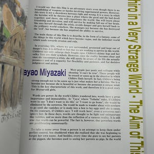 May include: An open book with text in English and Japanese. The title "Chihiro in a Very Strange World - The Aim of This Film" is visible. The text discusses the film's themes, characters, and the power of words.