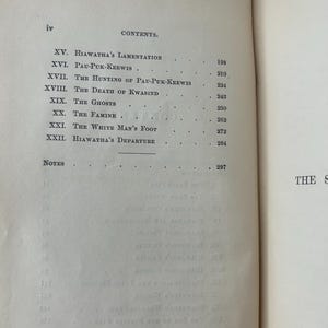 May include: Open book with a contents page. The page lists chapter titles such as "Hiawatha's Lamentation" and "The White Man's Foot." The text is in black ink on aged, off-white paper. The book's spine is visible on the right side.