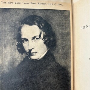May include: A black and white portrait of Henry Wadsworth Longfellow, a painting by C. G. Thompson, featured in The New York Times Book Review, April 4, 1943. The portrait shows a man with dark hair and a dark coat.