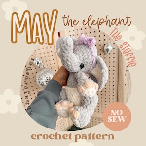 May include: A gray crochet elephant toy with a pink bow, cream-colored belly, and peach-colored feet. The text "MAY the elephant" and "crochet pattern" are displayed. The words "The Stuffie" and "NO SEW" are also visible.