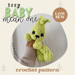 May include: A light green crocheted plush toy with black eyes and a stitched mouth. The text "itty BABY mean one" is above the toy, and "crochet pattern" is below. A brown circle reads "LOW SEW".