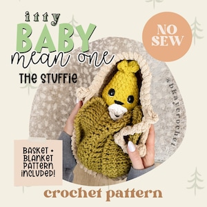 Könnte beinhalten: Ein gelbes und olivgrünes Häkel-Stofftier, eingewickelt in eine beige Decke. Der Text lautet: itty BABY mean one THE STUFFIE, NO SEW, BASKET + BLANKET PATTERN INCLUDED!, crochet pattern und @bkaycrochet. Das Stofftier hat schwarze Augen.