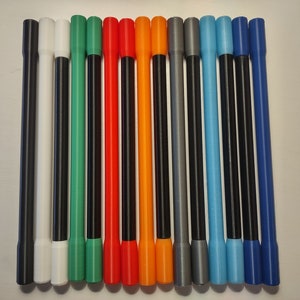 May include: A collection of colorful, long, cylindrical objects, each with a different color on the end. The colors include black, white, green, red, orange, gray, light blue, and dark blue. The objects are arranged vertically.