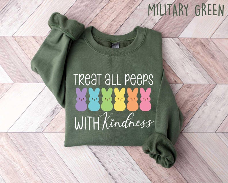 May include: A green sweatshirt with the text "Treat all peeps with kindness" and a row of colorful marshmallow peeps.