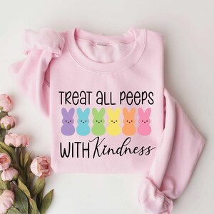 May include: Pink sweatshirt with a rainbow of Peeps and the text "Treat all peeps with kindness".