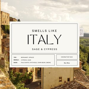 May include: A candle label with the text "Smells Like Italy Sage & Cypress" and a list of the candle's fragrance notes. The candle is made with coconut soy wax and is 9 ounces.
