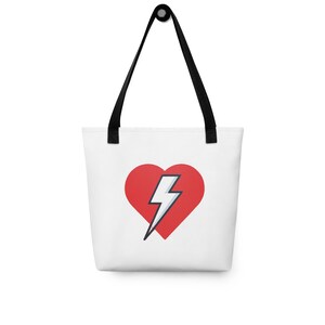 May include: White tote bag with a red heart with a white lightning bolt inside.