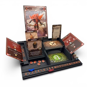 May include: A black plastic board game organizer featuring slots for cards, including a Red Guard character card, Iron Helmet, and Healing Potion. The base includes a numbered track from 0 to 20 with blue and red markers, and small circular tokens.