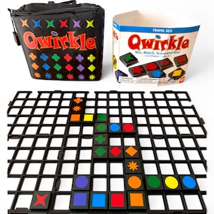 May include: A board game with the word "Qwirkle" on the box and carrying bag. The game includes a black grid and colorful tiles with various shapes. The bag is black with colorful star and diamond patterns. The box reads "Mix, Match, Score and Win!"