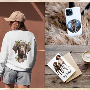 May include: A white sweatshirt with a brown and white dog wearing a flower crown printed on the front. The dog is a German Shorthaired Pointer. The sweatshirt is shown on a model wearing a brown baseball cap and denim shorts. The image also shows a phone case with the same dog design, a greeting card with the text "Dog Party!" and a cup of coffee.
