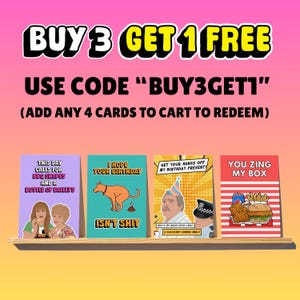 May include: A promotional image featuring four greeting cards on a wooden shelf. The cards have humorous designs and text. The top of the image has text that reads "BUY 3 GET 1 FREE" and "USE CODE 'BUY3GET1'".
