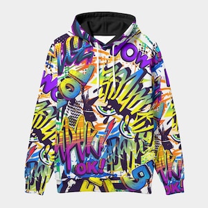 Puede incluir: Una sudadera con capucha blanca con forro negro, con un vibrante diseño de graffiti. El diseño incorpora letras audaces en varios colores, incluyendo amarillo, morado, naranja y azul, creando una estética dinámica y urbana.