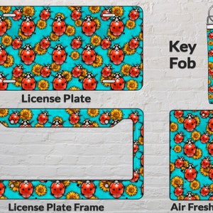 May include: A set of customizable car accessories featuring a repeating pattern of red ladybugs and yellow sunflowers on a turquoise background. The set includes a license plate, license plate frame, key fob, and air freshener.