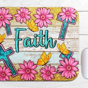 May include: A mouse pad with a woodgrain background and a gold glitter overlay. The design features pink flowers, blue crosses, and butterflies. The word "Faith" is written in turquoise blue letters.