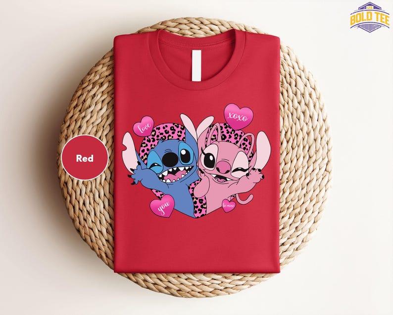 A red t-shirt with a cartoon image of two cartoon characters, one blue and one pink, along with heart-shaped symbols and the text "I love you".