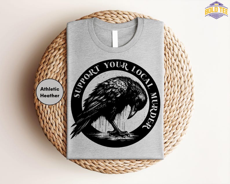 a grey t - shirt with a black bird on it