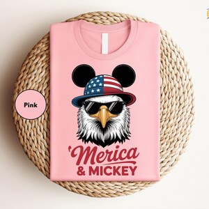 a pink shirt with an eagle wearing a hat and sunglasses