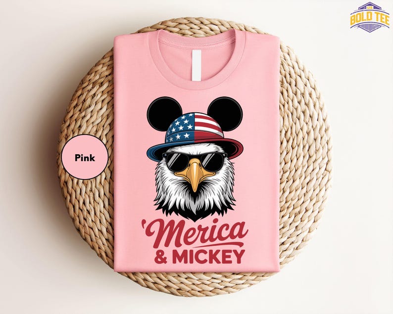 a pink shirt with an eagle wearing a hat and sunglasses