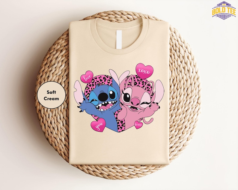 A t-shirt with a cartoon image of two cartoon characters, one blue and one pink, along with hearts and the text "Love you".