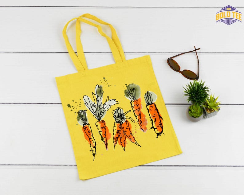 a yellow tote bag with carrots drawn on it