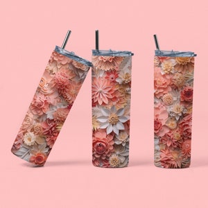 Op de afbeelding: Drie roestvrijstalen bekers met een bloemenpatroon. De bekers zijn roze, wit en crème met een 3D-papierbloemendesign.
