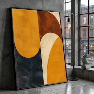 May include: Abstract art print with a black frame. The artwork features geometric shapes in shades of yellow, brown, and navy blue. The composition includes large, curved forms and a textured appearance, suitable for modern home decor.