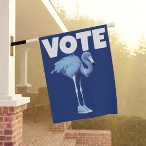 May include: A blue flag with the word "VOTE" in white letters and a blue flamingo wearing white sneakers. The flamingo is standing on a blue background.