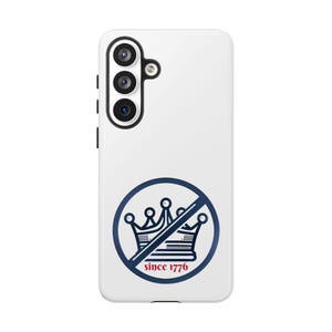 May include: White phone case with a navy blue graphic of a crown with a line through it, inside a circle. The text "since 1776" is below the crown. The phone case has a camera and flash.