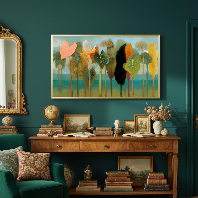 May include: A framed art print depicting stylized trees with colorful foliage, including orange, green, and yellow leaves. The artwork hangs above a wooden console table with books, framed pictures, and a globe. The room has teal walls and a gold-framed mirror.