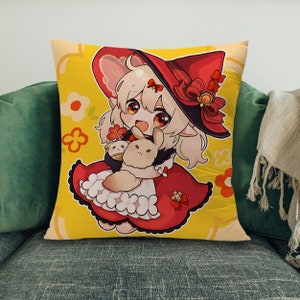 May include: A yellow pillow with a cartoon illustration of a girl wearing a red hat and dress. She is holding two white bunnies. The background has a floral pattern.