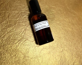May include: A brown glass bottle with a black cap and a white label that reads "A Walk in the Park Chloe by Chloe".