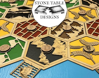 May include: A wooden game board with hexagonal tiles featuring different designs, including trees, wheat, and brick. Each tile has a number on it. The board is labeled "Stone Table Designs".