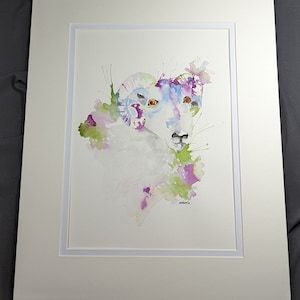 May include: Watercolor painting of a white ram with large curled horns. The ram's face is visible, with orange eyes and a pink nose. The background is a watercolor wash of purple, green, and blue.