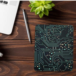 May include: A black mouse pad with a circuit board design featuring green and yellow lines and dots.
