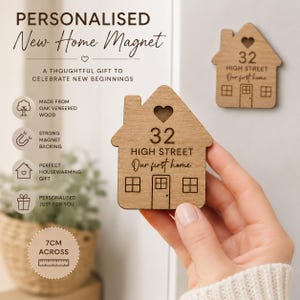 May include: A house-shaped magnet made of oak veneered wood, measuring 7 cm across. The magnet features an engraved heart cutout at the top, the number 32, the text HIGH STREET, and the script text Our first home, with a door and window design.