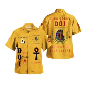 May include: Yellow button-down shirt with short sleeves. The front features text and symbols, including an ankh and an eye symbol. The back of the shirt has a large graphic with text that reads "Your Court DOI Daughters".