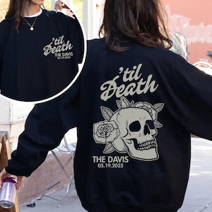 May include: Black sweatshirt with a skull and rose graphic on the back, with the text "'til Death" and "THE DAVIS 05.19.2025". The front of the sweatshirt also has the text "'til Death" and "THE DAVIS 05.19.2025".
