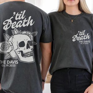 May include: Two dark gray t-shirts with the text "'til Death" and "THE DAVIS 05.19.2025" printed in white. One shirt features a skull and rose graphic on the back. The other shirt has the text on the front.