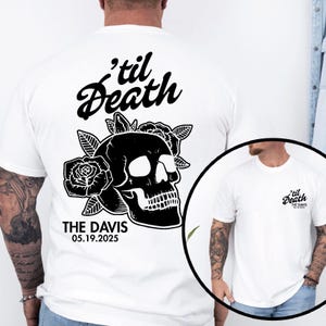 May include: White t-shirt featuring a black skull design with roses and the text "'til Death" above and "THE DAVIS 05.19.2025" below. The design is on the back of the shirt. A smaller version of the design is on the front.