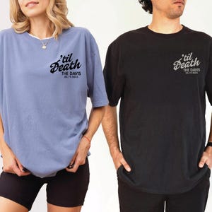 May include: Two short-sleeved t-shirts, one light blue and one black, each featuring the phrase "'til Death" in a script font, along with "THE DAVIS" and the date "05.19.2025". The shirts are worn by two people.