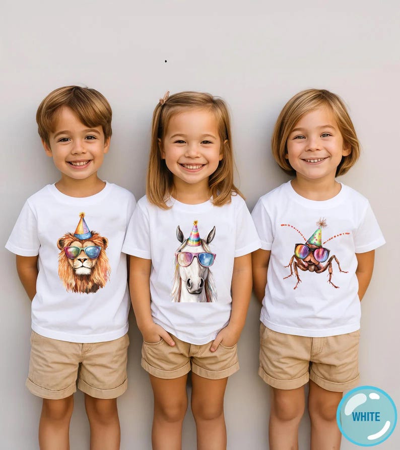 May include: Three white t-shirts featuring graphic prints of a lion, a horse, and a cockroach, each wearing a colorful party hat and rainbow-tinted sunglasses. The shirts are paired with tan shorts, creating a coordinated set of casual clothing.