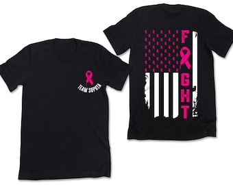 May include: Two black t-shirts. One has a pink ribbon and the text "Team Sophia". The other has a pink ribbon design, white stripes, and the word "FIGHT" in pink. The design resembles a flag.