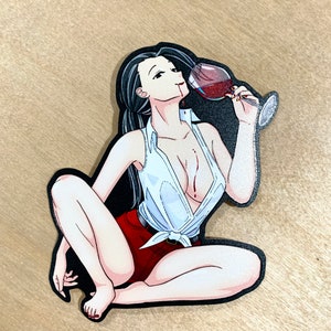 May include: A sticker featuring a woman with long black hair, wearing a white shirt and red shorts, sitting with her legs crossed and drinking from a glass of red wine.