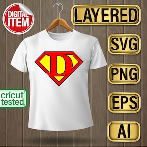 May include: A white t-shirt with a red and yellow Superman logo featuring the letter "D" in the center. The image includes the text "LAYERED", "SVG", "PNG", "EPS", and "AI" in gold boxes.