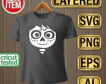 May include: A dark gray t-shirt with a white graphic of Miguel from the movie Coco. The graphic is a close-up of Miguel's face, showing his skull and his hair. The t-shirt is on a hanger and there are several gold buttons with text on them, including "Layered", "SVG", "PNG", "EPS", and "AI".