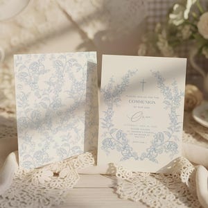 May include: Two invitation cards with a floral design in light blue. One card features a full floral pattern, while the other has a floral wreath around the text "PLEASE JOIN US FOR THE COMMUNION OF OUR SON".