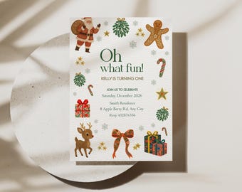 May include: A festive invitation with the text "Oh what fun!" and "Kelly is turning one." The design includes illustrations of Santa Claus, a gingerbread man, candy canes, a reindeer, gifts, and a bow. The invitation is on a white background with decorative elements.