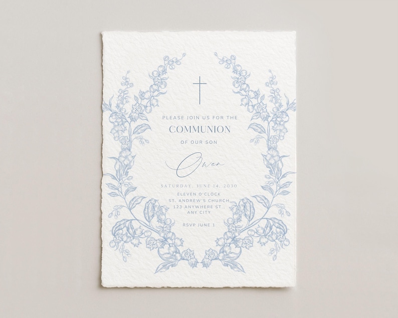 May include: A light blue floral wreath frames a Communion invitation on textured paper. The invitation includes the text "Please join us for the Communion of our son" and event details. A cross is at the top of the invitation.